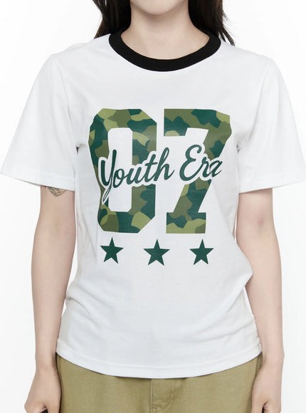Camo Graphic T-Shirt IL522 White close-up front detail shot on model showing green camouflage 07 Youth Era lettering three green star motifs black ringer neckline cotton