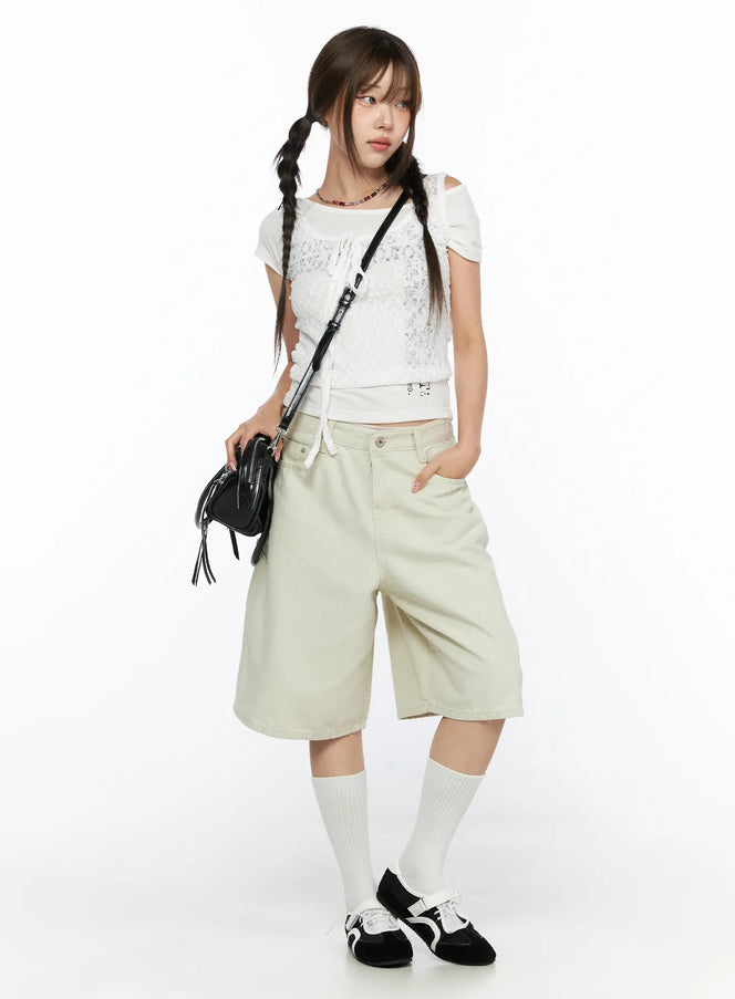 LEWKIN Cargo Bermuda Shorts CL514 Light beige front shot on model with braided pigtails, styled with white lace crop top and black crossbody bag