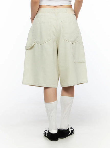 Cargo Bermuda Shorts CL514 Light beige back shot on model showing dual back pockets and wide-leg silhouette with white knee-high socks