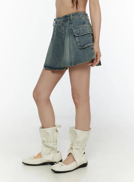 Cargo Pleated Vintage Wash Denim Skirt CL507 Blue side shot on model showing cargo pocket and pleated silhouette styled with plaid shirt and white bag