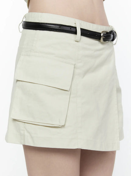 Cargo Pocket Wrap Skirt IL522 Light beige close-up side detail showing large cargo flap pocket and black leather belt against cotton twill fabric