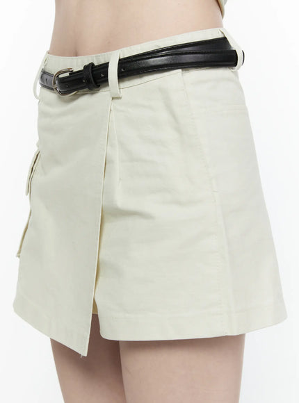 Cargo Pocket Wrap Skirt IL522 Light beige close-up side detail showing right panel wrap overlap, belt loops, and black leather belt buckle