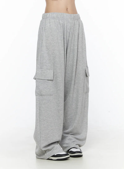 LEWKIN Cargo Wide Leg Sweatpants CL524 Gray side shot on model cropped at waist showing elastic waistband and flap cargo pockets on wide-leg heathered cotton jogger