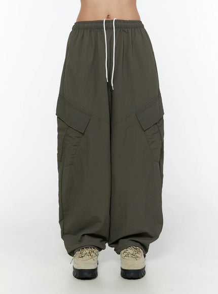 LEWKIN Cargo Wide Parachute Pants CU526 Dark gray front crop shot on model showing elastic drawstring waistband and dual cargo pockets in nylon fabric