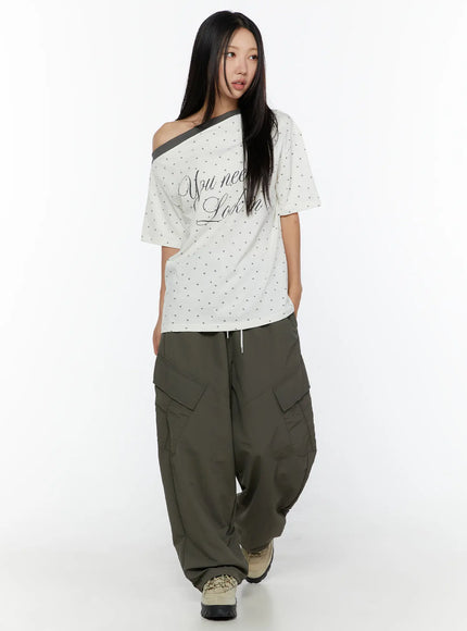 Cargo Wide Parachute Pants CU526 Dark gray full-body front shot on model with off-shoulder graphic tee styled with chunky sneakers walking pose