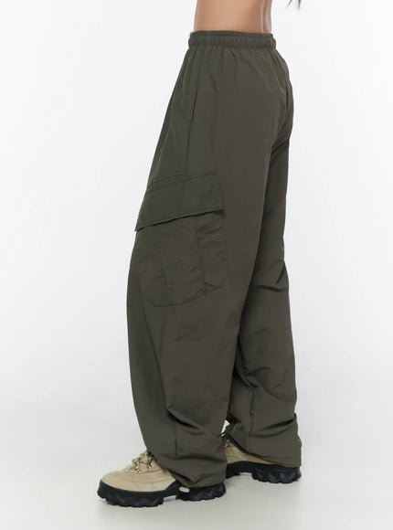 Cargo Wide Parachute Pants CU526 Dark gray side shot on model showing large flap cargo pocket elastic waistband and wide ballooned leg silhouette