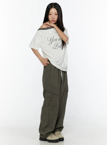 Cargo Wide Parachute Pants CU526 Dark gray side full-body shot on model with hand on hip showing diagonal seam detailing and oversized parachute silhouette