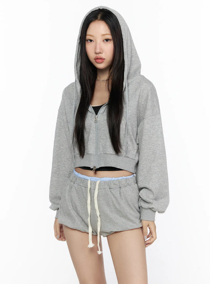 Casual Cropped Hoodie CL527 Gray front shot on model with hood up zip partially open oversized crop silhouette styled with matching gray shorts