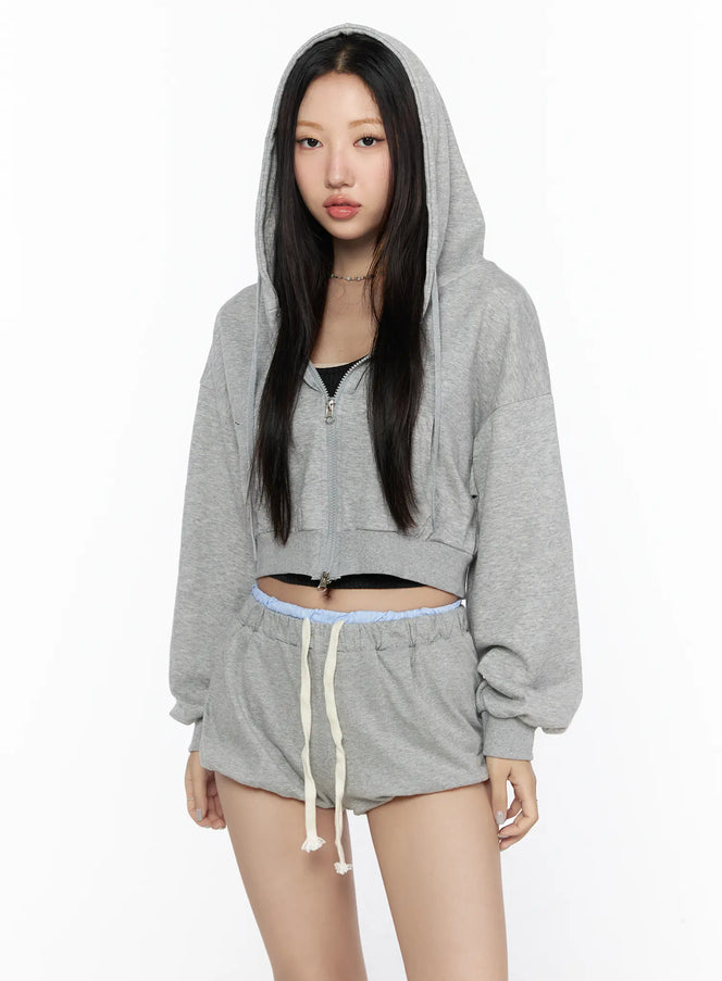 Casual Cropped Hoodie CL527 Gray front shot on model with hood up zip partially open oversized crop silhouette styled with matching gray shorts