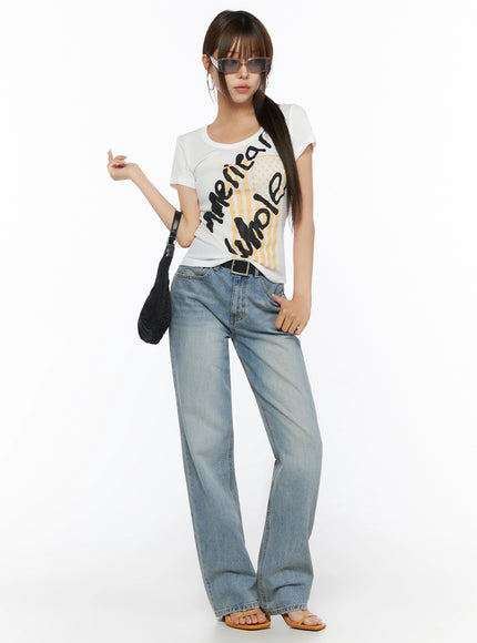 Casual Graphic Short Sleeve Tee IL523 White full-body front shot on model styled with sunglasses black shoulder bag belt wide-leg jeans and tan sandals
