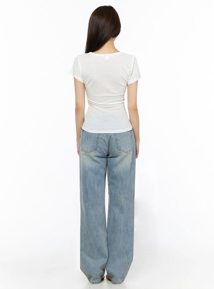Casual Graphic Short Sleeve Tee IL523 White full-body back shot on model showing plain white back panel fitted waist and short sleeve construction with wide-leg jeans