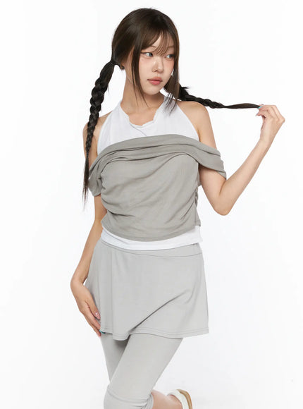 Casual Layered Halter Top CL517 Beige three-quarter front shot on model holding braid layered draped off-shoulder knit top over white halter