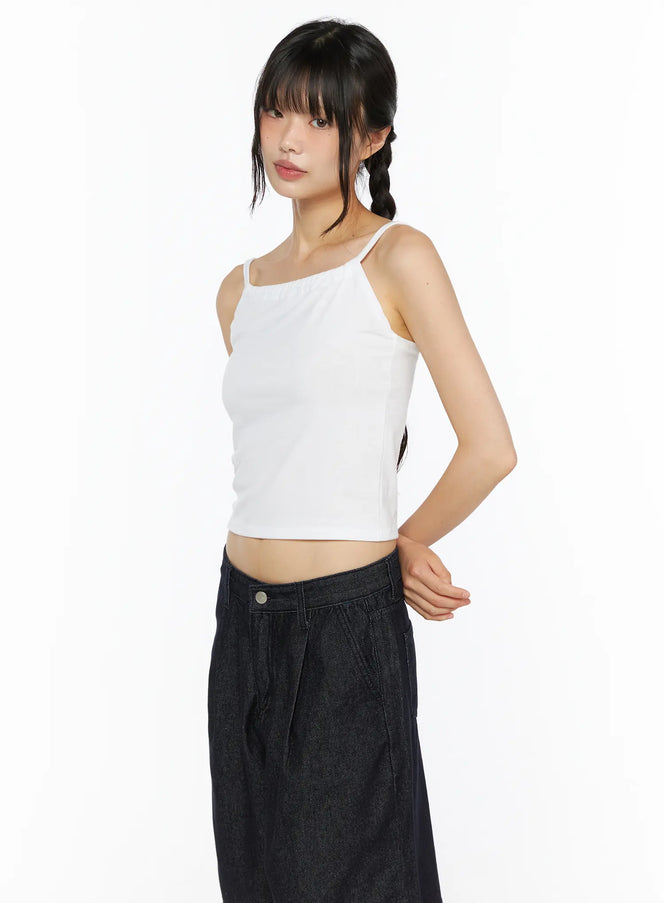 LEWKIN Casual Sleeveless Top CU530 White side shot on model wearing braided pigtails, cropped ribbed camisole with thin straps paired with dark denim