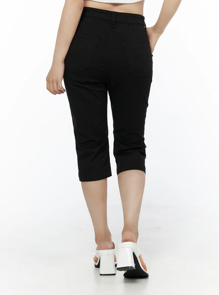 Casual Slim-Fit Capri Pants IU525 Black back view on model walking away showing rear patch pockets, high waistband, and cropped hem