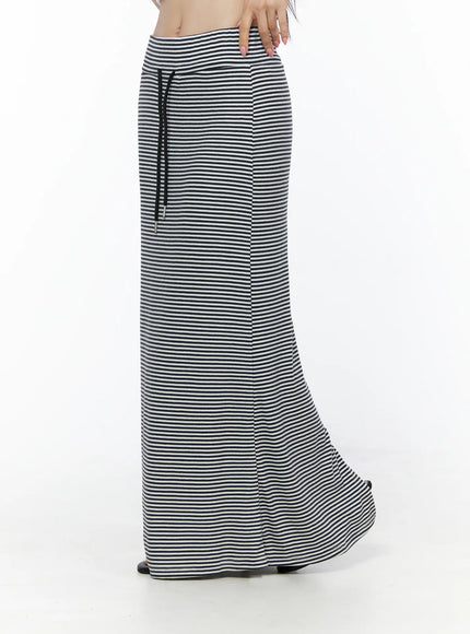 Casual Striped Drawstring Maxi Skirt IU525 White side close-up on model showing black drawstring waist detail and vertical drape of stripe fabric