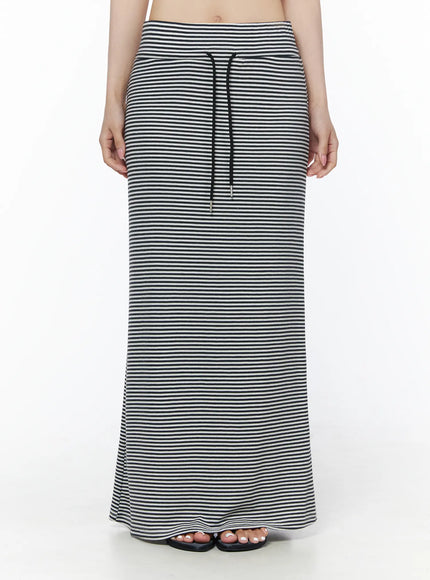 LEWKIN Casual Striped Drawstring Maxi Skirt IU525 White front close-up on model showing black drawstring waistband and fine horizontal stripe knit fabric