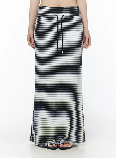 LEWKIN Casual Striped Drawstring Maxi Skirt IU525 White front close-up on model showing black drawstring waistband and fine horizontal stripe knit fabric