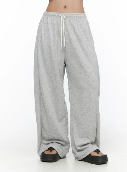 Casual Wide Leg Sweatpants CL513 Gray front mid-body shot on model showing white drawstring waistband wide leg fit and hem stacking over black platform sandals