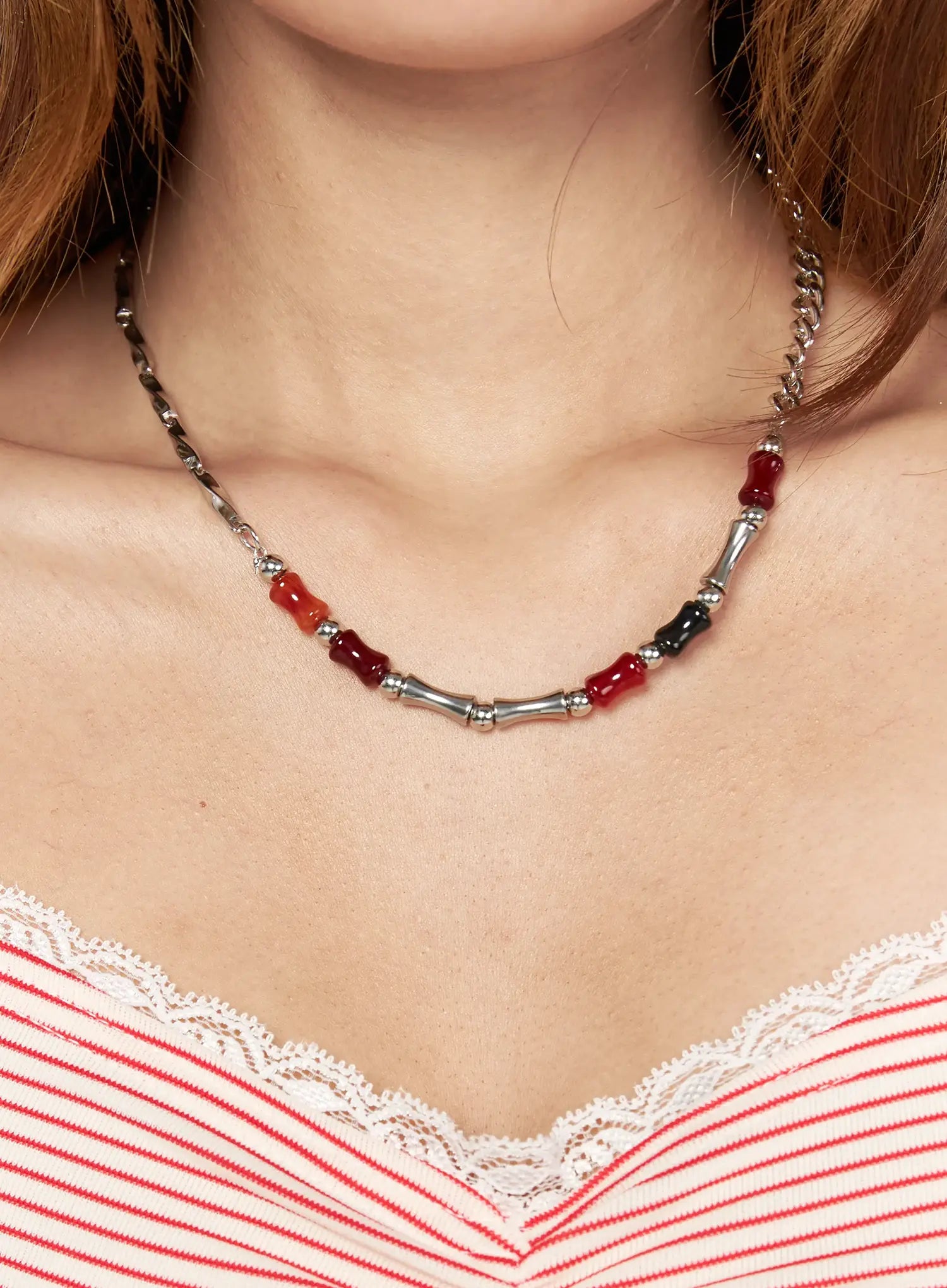 LEWKIN Celeste Link Necklace IL517 silver close-up on model neck showing red and black stone beads with bamboo-style silver tubes worn over red striped lace-trim top