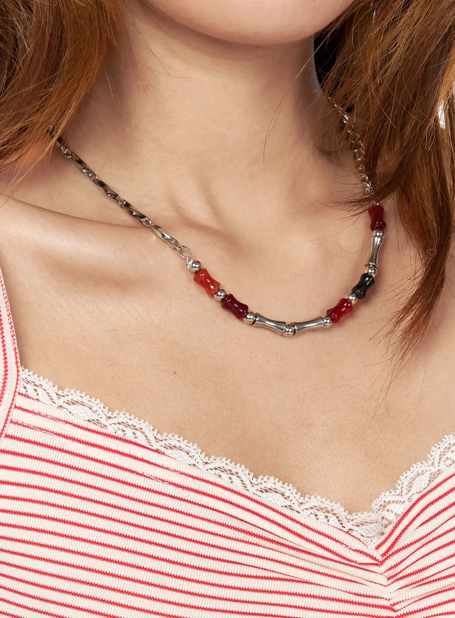 Celeste Link Necklace IL517 silver wider model neck shot displaying full necklace drape with red and black stone beads bamboo tubes and mixed chain styling over striped lace-trim top