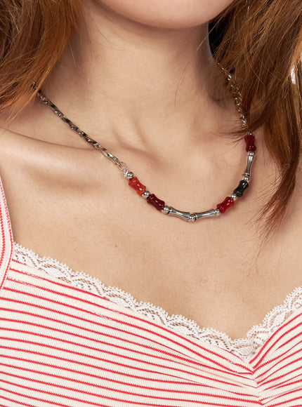 Celeste Link Necklace IL517 silver wider model neck shot displaying full necklace drape with red and black stone beads bamboo tubes and mixed chain styling over striped lace-trim top