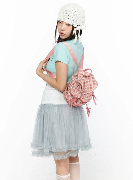 Checked Ribbon Backpack CL517 Pink three-quarter back view on model wearing teal top showing plaid body gingham bows and pink satin straps