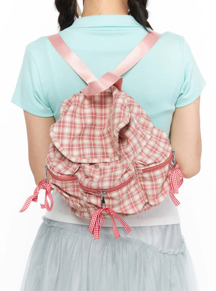 Checked Ribbon Backpack CL517 Pink back view on model showing crossed pink satin shoulder straps ruffle flap and red gingham ribbon details