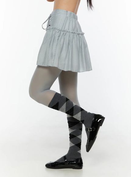 Chiffon Flare Mini Skirt CU526 Light blue side shot on model with one leg raised showing back zipper closure and ruched elastic waist detail