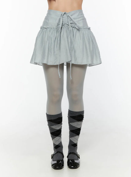 Chiffon Flare Mini Skirt CU526 Light blue front waist-down shot on model showing full drawstring waistband, ruffled tier, and flared hem over gray tights