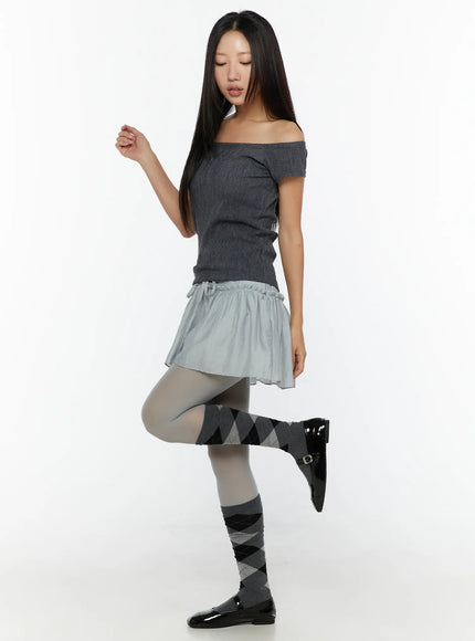 Chiffon Flare Mini Skirt CU526 Light blue side full-body shot on model with one knee raised showing drawstring ties and flared silhouette
