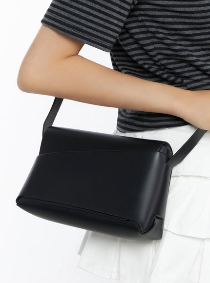LEWKIN Classic Faux Leather Crossbody Bag IL523 Black close-up detail shot held under model's arm against striped top and white skirt