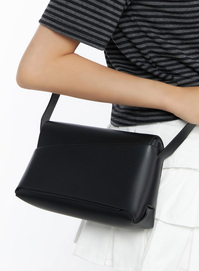 LEWKIN Classic Faux Leather Crossbody Bag IL523 Black close-up detail shot held under model's arm against striped top and white skirt