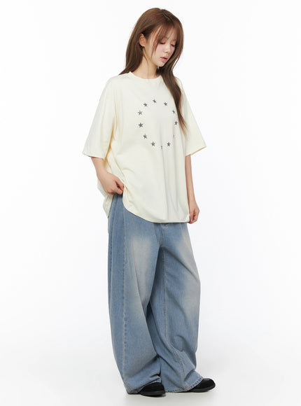 Coleen Side Pleat Baggy Jeans IL502 Blue three-quarter front view on model in side-turned pose styled with cream oversized tee showing volume and length