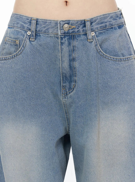 Coleen Side Pleat Baggy Jeans IL502 Blue close-up detail of waistband button fly and front pockets with faded wash denim texture on model