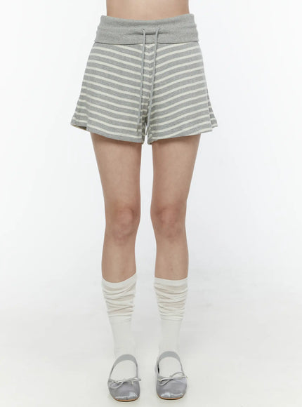 Colette Striped Banding Shorts IL506 Gray front shot on model from waist down showing fold-over waistband drawstring and flared knit stripe shorts with slouch socks and ballet flats