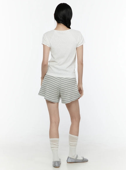 Colette Striped Banding Shorts IL506 Gray full-body back shot on model styled with white dotted tee showing back of flared stripe shorts slouch socks and silver ballet flats