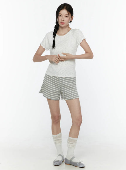 Colette Striped Banding Shorts IL506 Gray full-body front shot on model styled with white dotted tee hands at waist slouch socks and silver ballet flats facing forward