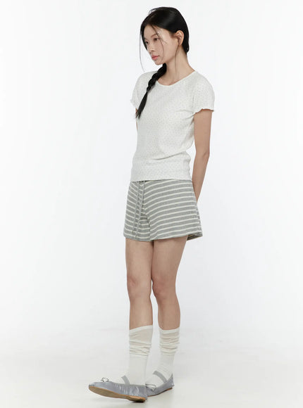 Colette Striped Banding Shorts IL506 Gray side shot on model styled with white dotted tee slouch socks and silver ballet flats standing in profile looking down