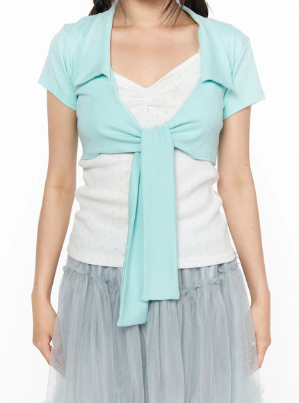 Collared Tie Short Sleeve Crop Bolero CL514 Mint close-up front shot model showing mint crop bolero with wide collar front tie detail layered over white eyelet top and gray tulle skirt