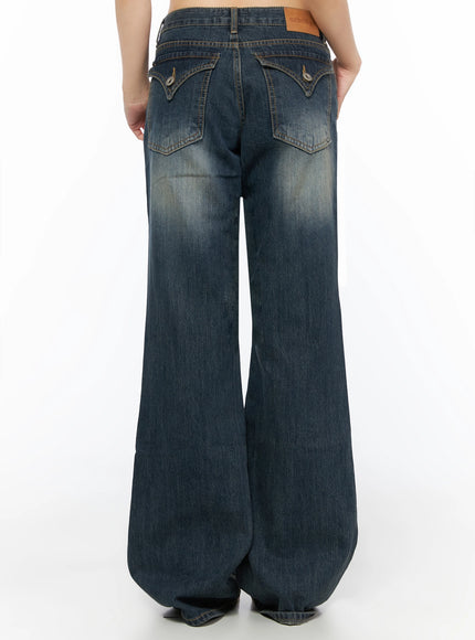 Collins Vintage Washed Bootcut Jeans IL523 Dark blue back view on model showing full-length wide bootcut flare vintage wash and ozbridge leather patch label at waist