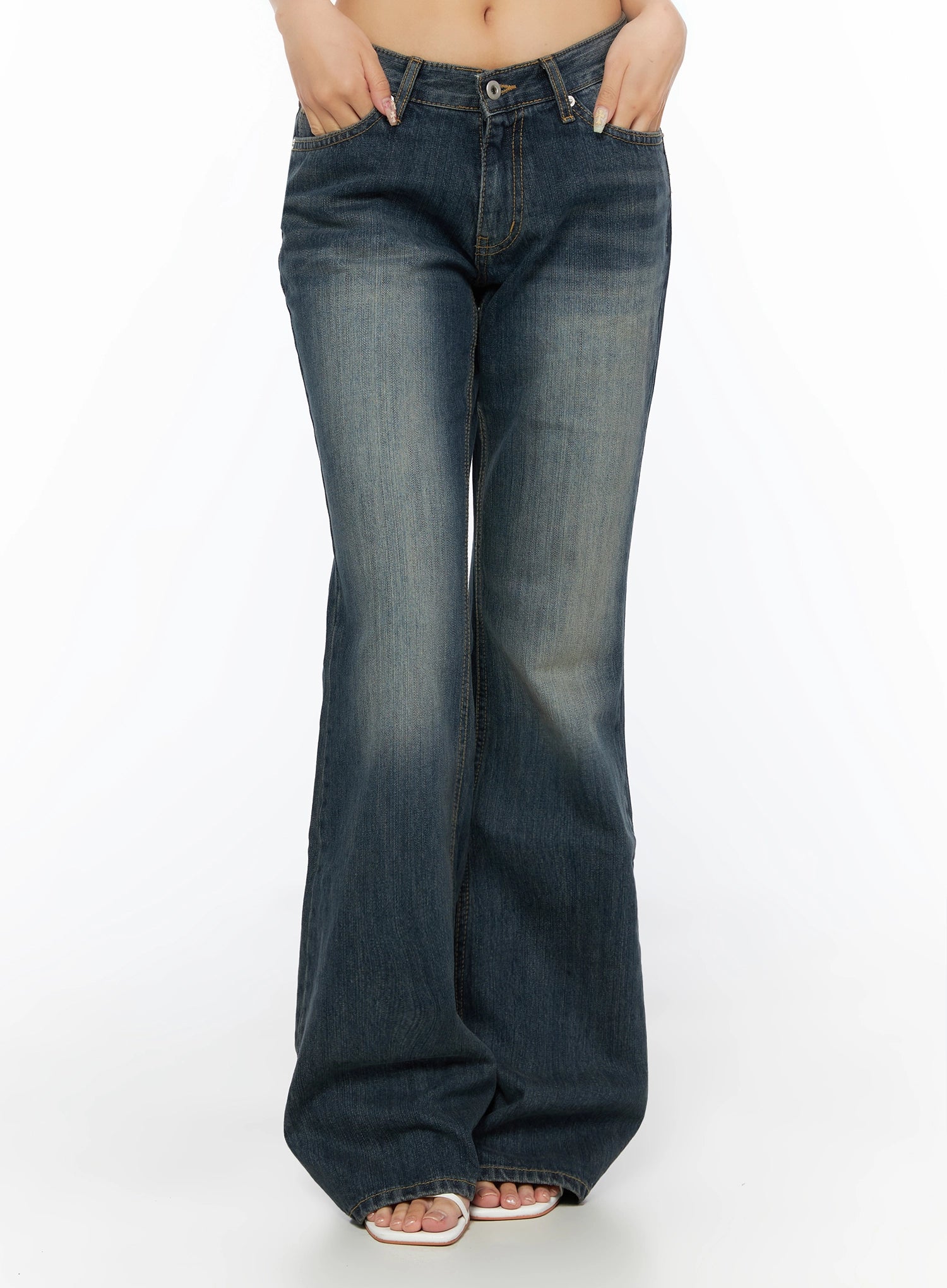 Collins Vintage Washed Bootcut Jeans IL523 Dark blue front shot cropped at waist model hands in pockets showing faded wash low-rise waistband and wide bootcut legs
