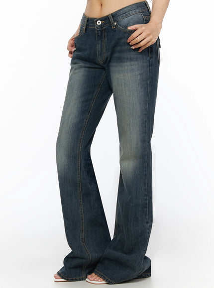 Collins Vintage Washed Bootcut Jeans IL523 Dark blue side shot on model showing low-rise fit hand in pocket V-shaped waistband and flared bootcut leg silhouette