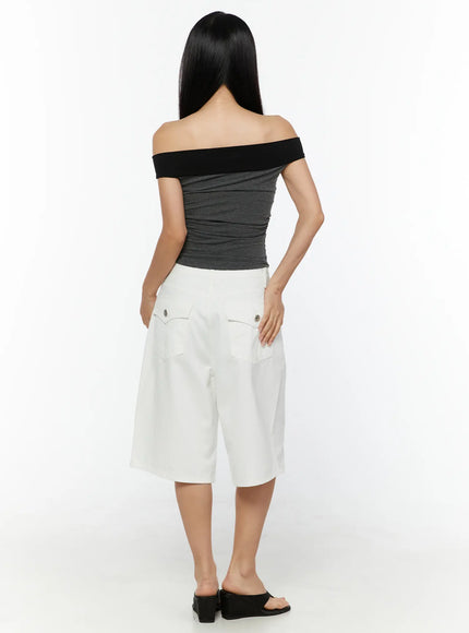 Color Contrast Off-Shoulder Graphic Top CU529 Dark gray back model shot showing off-shoulder black band and ruched striped knit back panel paired with white wide-leg shorts