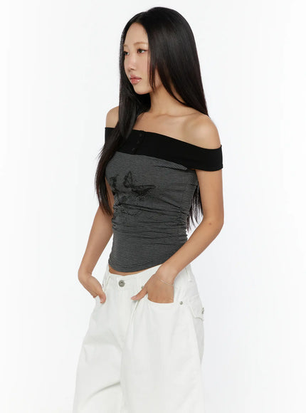 Color Contrast Off-Shoulder Graphic Top CU529 Dark gray side model shot close-up cropped torso view highlighting butterfly graphic print and ruched striped texture with black shoulder band