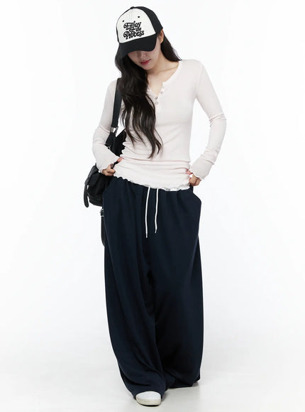 Color Contrast Wide-Leg Sweatpants IU525 Dark blue full-length styled shot on model with baseball cap and crossbody bag, oversized wide-leg fit
