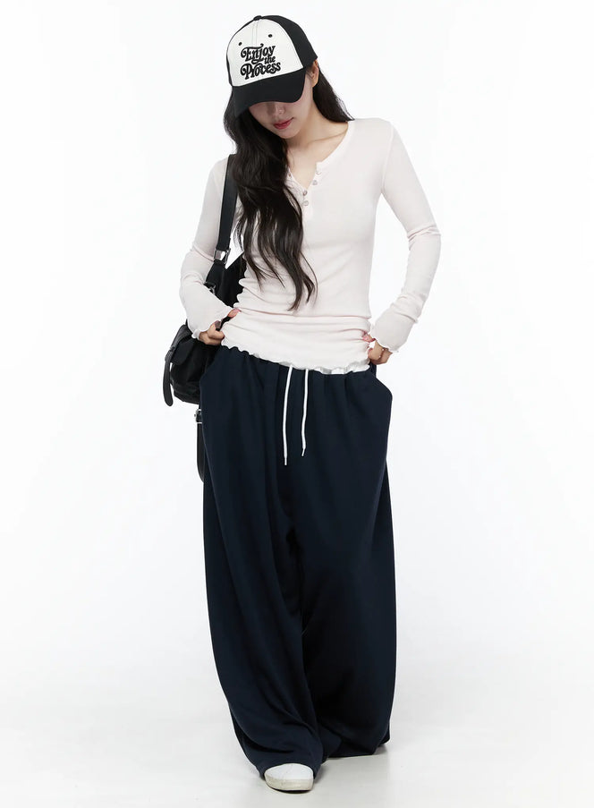 Color Contrast Wide-Leg Sweatpants IU525 Dark blue full-length styled shot on model with baseball cap and crossbody bag, oversized wide-leg fit
