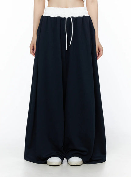 LEWKIN Color Contrast Wide-Leg Sweatpants IU525 Dark blue front view on model wearing white crop top, white elastic waistband with drawstring, ultra-wide leg silhouette