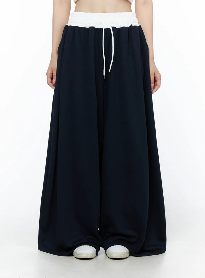 LEWKIN Color Contrast Wide-Leg Sweatpants IU525 Dark blue front view on model wearing white crop top, white elastic waistband with drawstring, ultra-wide leg silhouette