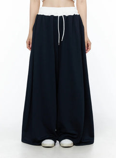 LEWKIN Color Contrast Wide-Leg Sweatpants IU525 Dark blue front view on model wearing white crop top, white elastic waistband with drawstring, ultra-wide leg silhouette