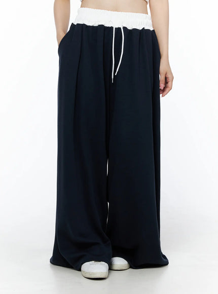 Color Contrast Wide-Leg Sweatpants IU525 Dark blue front view on model in white crop top, white elastic waistband with drawstring detail, roomy leg opening